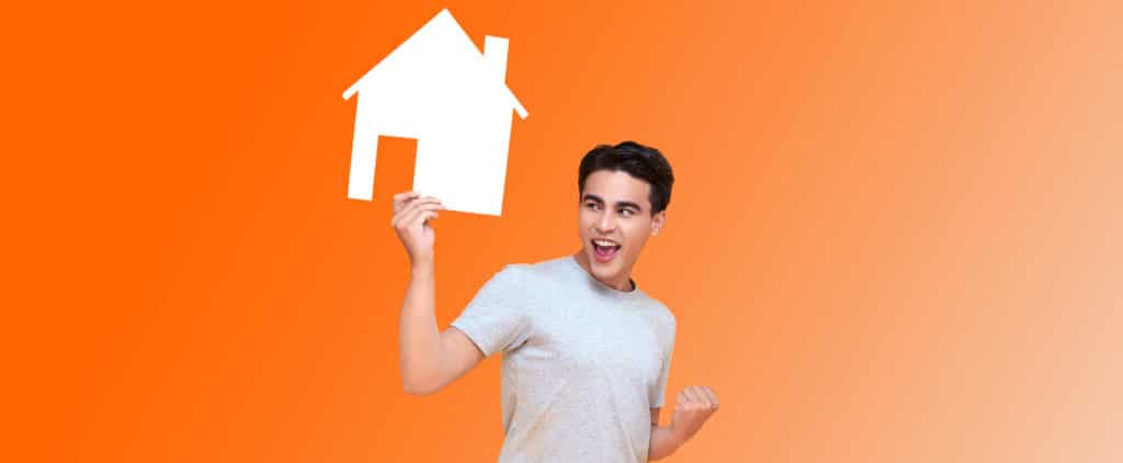Man with a refinanced mortgage holding up a cardboard cutout of a home symbol