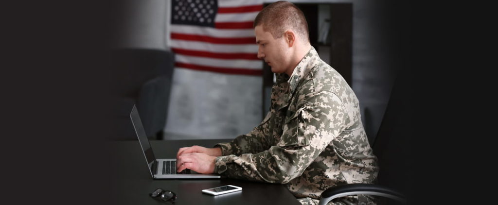 Military man working on laptop