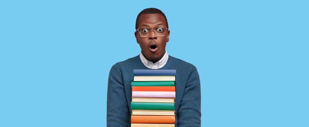 Shocked college student carrying books