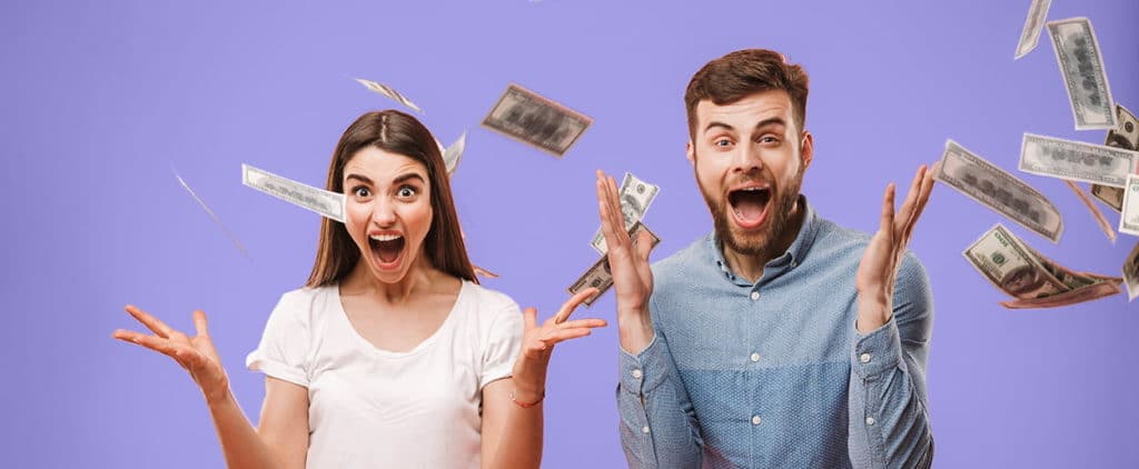 Excited couple throwing money in the air
