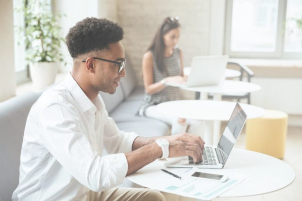 Man on laptop checking student loan refinancing rates